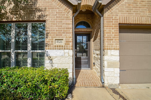 doorway to property featuring a garage