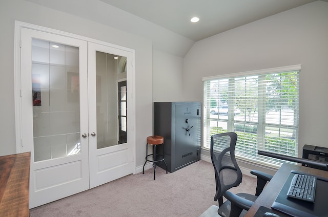 carpeted home office featuring french doors and vaulted ceiling