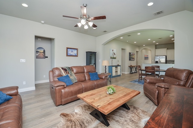 living room featuring light hardwood / wood-style floors and ceiling fan