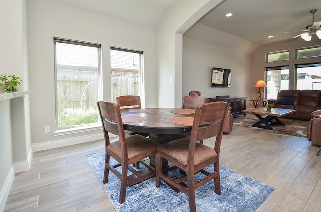 dining area with light hardwood / wood-style floors, a healthy amount of sunlight, and ceiling fan