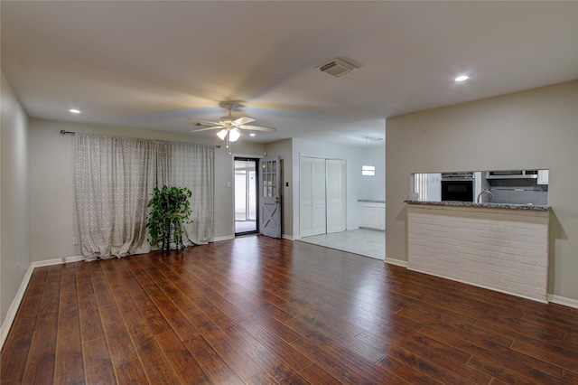 unfurnished living room with a ceiling fan, wood finished floors, visible vents, baseboards, and recessed lighting