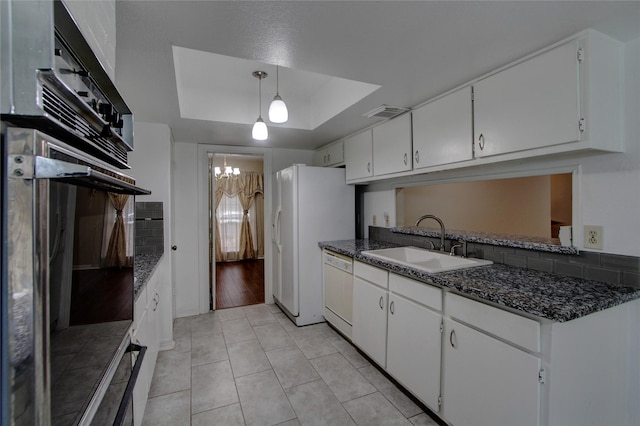 kitchen featuring a sink, white appliances, white cabinets, light tile patterned flooring, and a raised ceiling