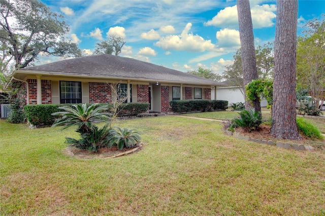 single story home featuring a garage, brick siding, a front yard, and a shingled roof