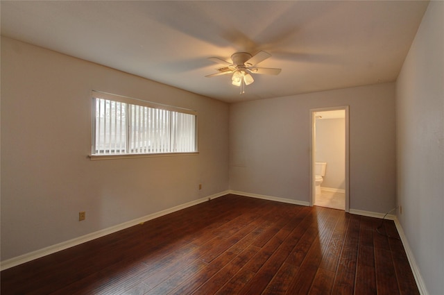 empty room featuring dark wood-style floors, baseboards, and ceiling fan