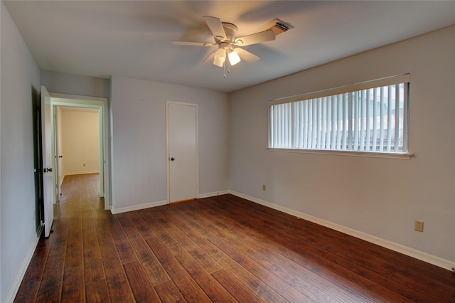 unfurnished bedroom with dark wood-style floors, baseboards, and ceiling fan