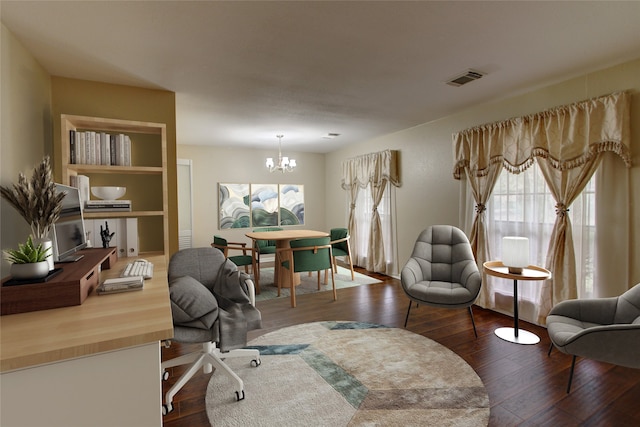 home office with dark wood-style floors, visible vents, a wealth of natural light, and a chandelier