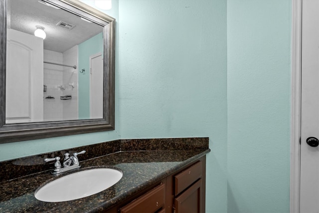 bathroom featuring vanity and a textured ceiling