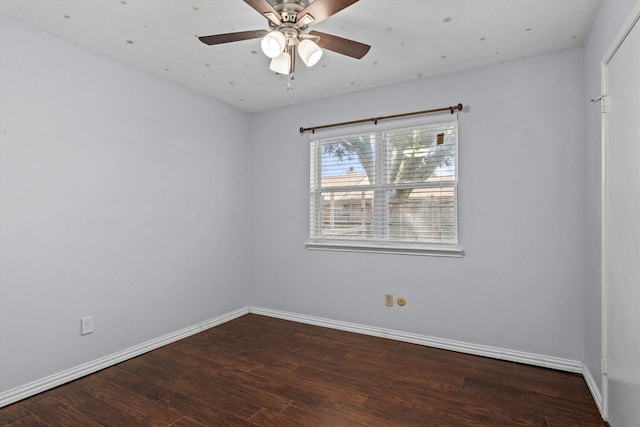 spare room featuring ceiling fan and dark hardwood / wood-style flooring