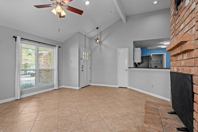 unfurnished living room with vaulted ceiling with beams, ceiling fan, a fireplace, and light tile patterned floors