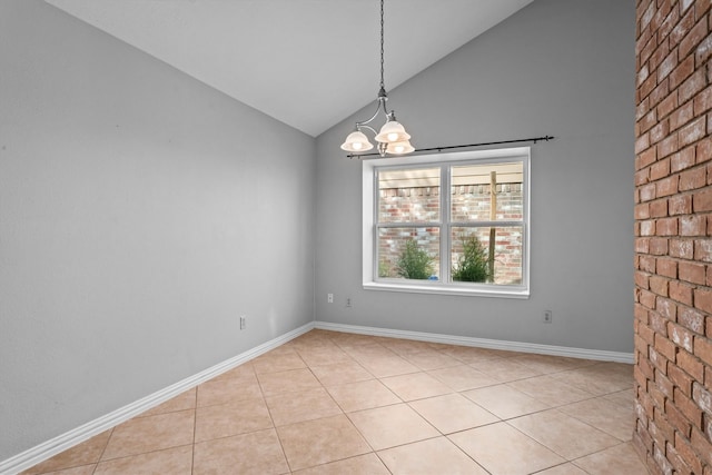 tiled empty room with an inviting chandelier and vaulted ceiling