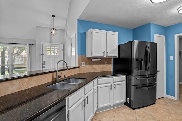 kitchen featuring white cabinets, pendant lighting, sink, and fridge with ice dispenser