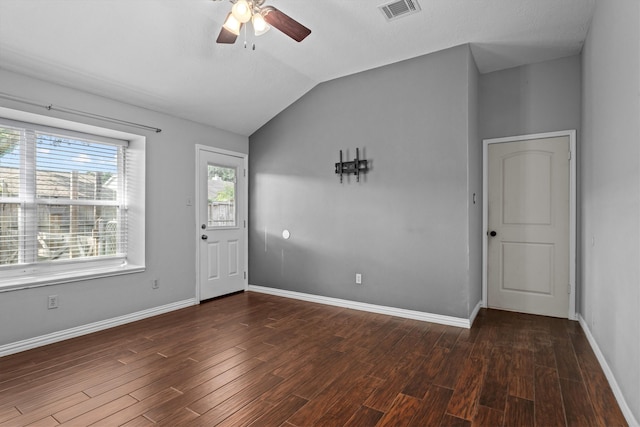 unfurnished room featuring ceiling fan, dark hardwood / wood-style flooring, and vaulted ceiling