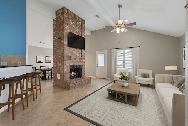 living room featuring a fireplace, visible vents, beam ceiling, and light tile patterned flooring