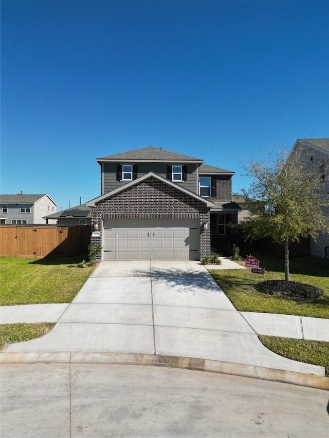 view of front of house featuring a front lawn and a garage