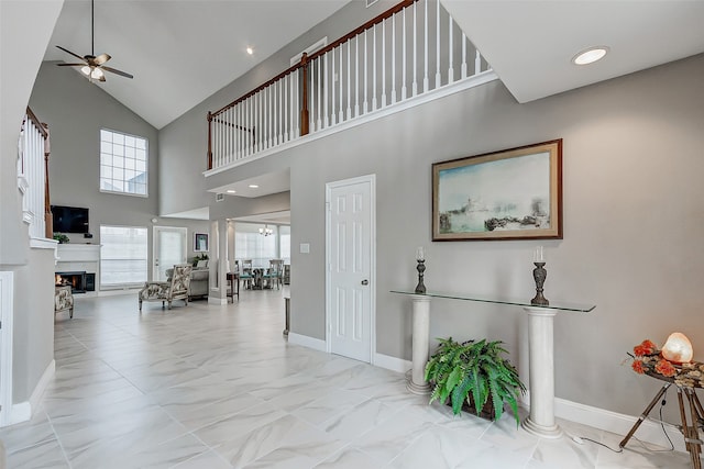 interior space featuring ceiling fan and high vaulted ceiling