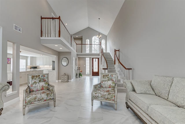 living room with high vaulted ceiling and a chandelier