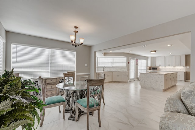 dining area with an inviting chandelier