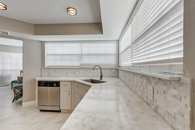 kitchen with sink, white cabinets, dishwasher, and a healthy amount of sunlight