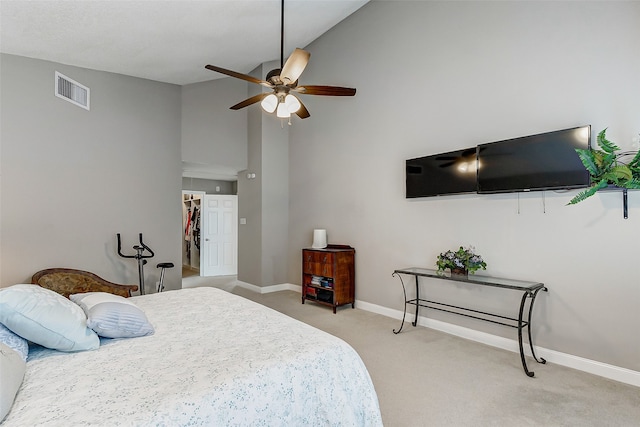 carpeted bedroom featuring a closet, ceiling fan, high vaulted ceiling, and a walk in closet