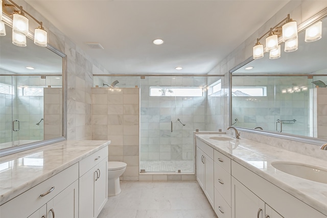 bathroom featuring tile walls, vanity, toilet, and an enclosed shower