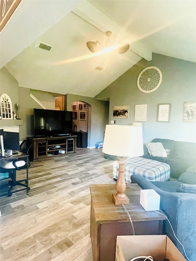 living room featuring hardwood / wood-style flooring and vaulted ceiling with beams