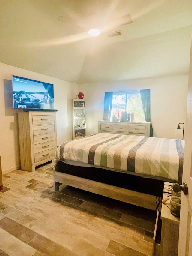 bedroom featuring lofted ceiling, hardwood / wood-style flooring, and ceiling fan