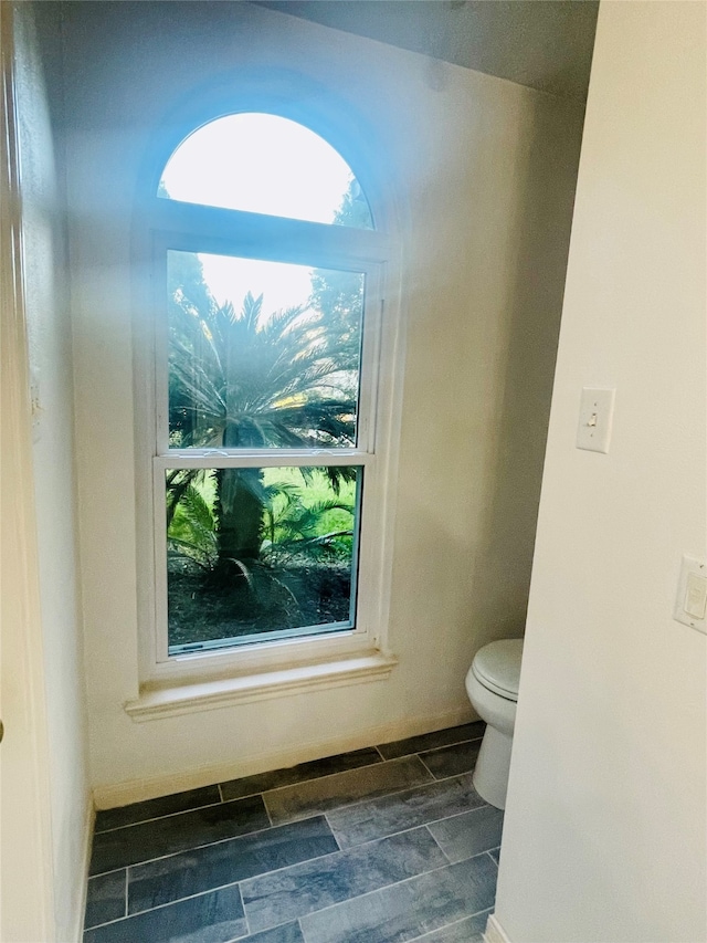 bathroom featuring hardwood / wood-style floors and toilet