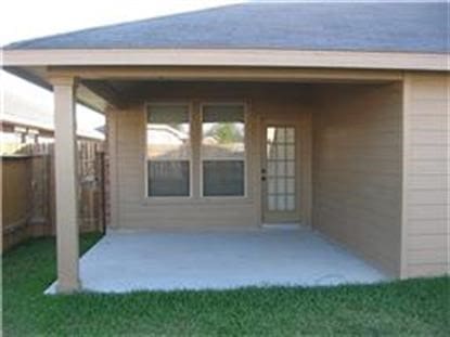 view of exterior entry featuring a patio area