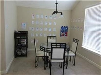 carpeted dining room with plenty of natural light