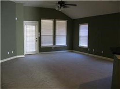 unfurnished living room with ceiling fan, vaulted ceiling, and carpet floors