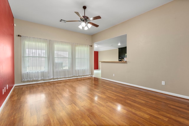 empty room featuring hardwood / wood-style flooring and ceiling fan