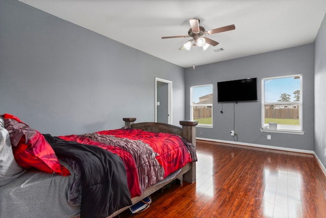 bedroom with ceiling fan and dark hardwood / wood-style flooring