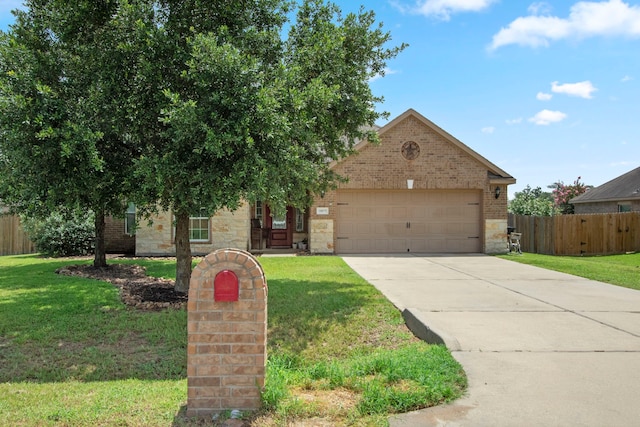 view of property hidden behind natural elements featuring a front yard and a garage