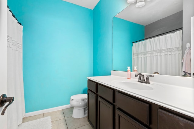 bathroom featuring tile patterned flooring, vanity, and toilet