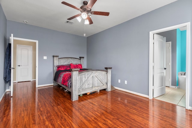 bedroom with hardwood / wood-style floors, ceiling fan, and connected bathroom