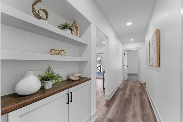 corridor featuring dark hardwood / wood-style flooring