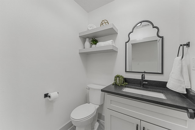 bathroom with toilet and vanity