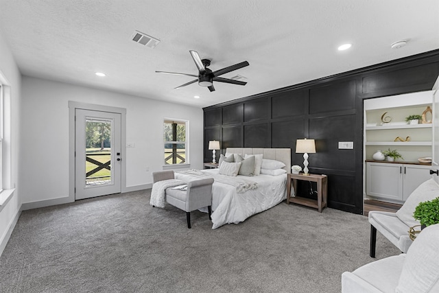 bedroom featuring ceiling fan, access to outside, a textured ceiling, and carpet floors