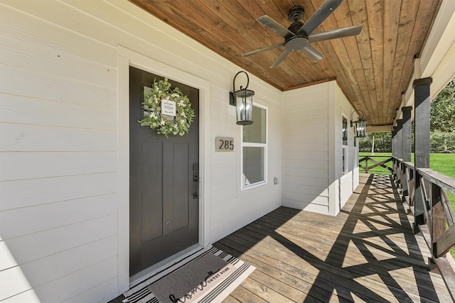 entrance to property with a porch and ceiling fan