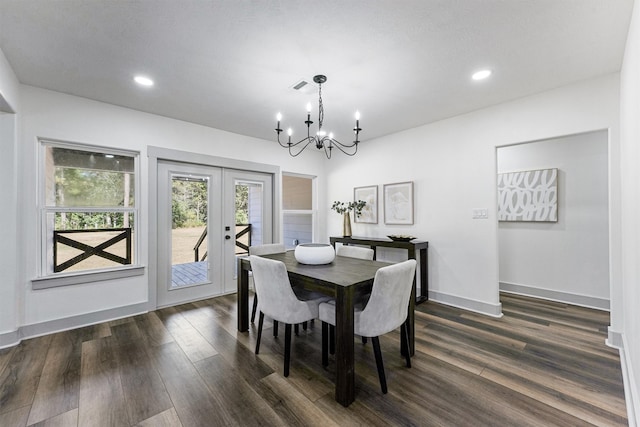 dining room featuring french doors, a notable chandelier, dark hardwood / wood-style floors, and a textured ceiling