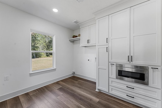 kitchen featuring dark wood-type flooring and white cabinetry