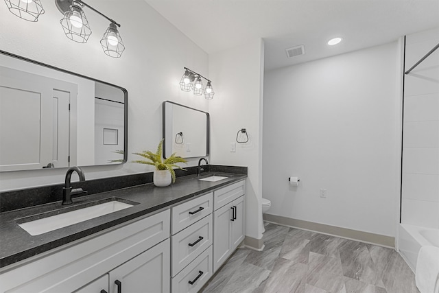 full bathroom featuring vanity, toilet, and tub / shower combination