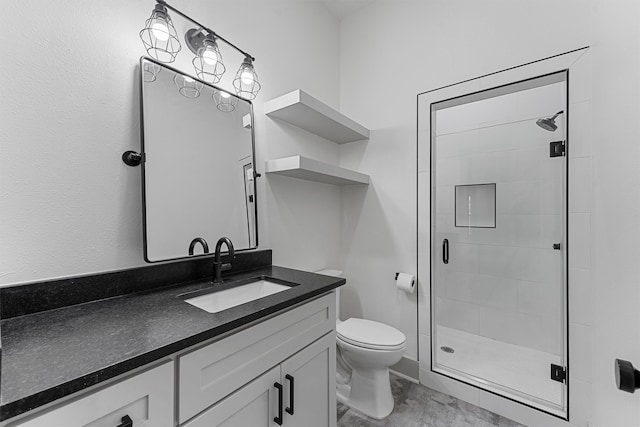 bathroom featuring vanity, a shower with shower door, and toilet