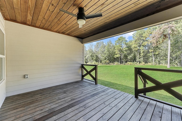 wooden terrace featuring a yard and ceiling fan