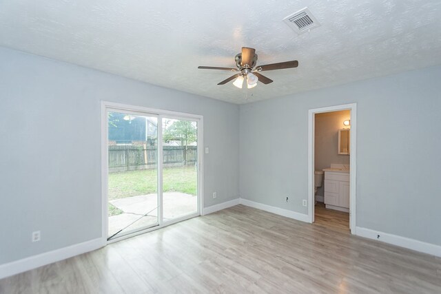 empty room featuring ceiling fan, a textured ceiling, and light wood-type flooring