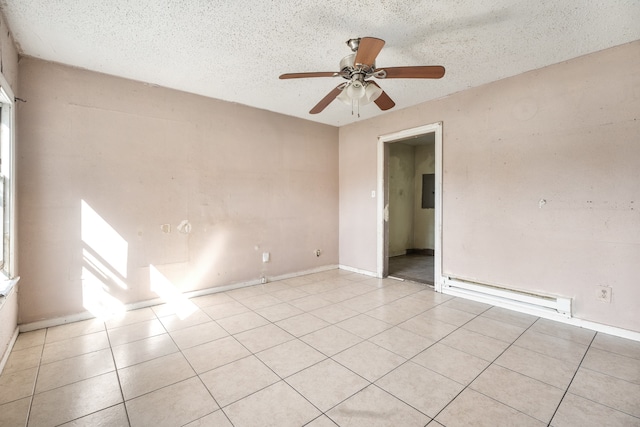 tiled spare room with ceiling fan, a textured ceiling, and a baseboard heating unit