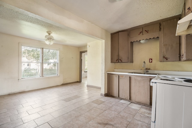 kitchen featuring a textured ceiling, white electric range oven, light tile patterned flooring, sink, and ventilation hood