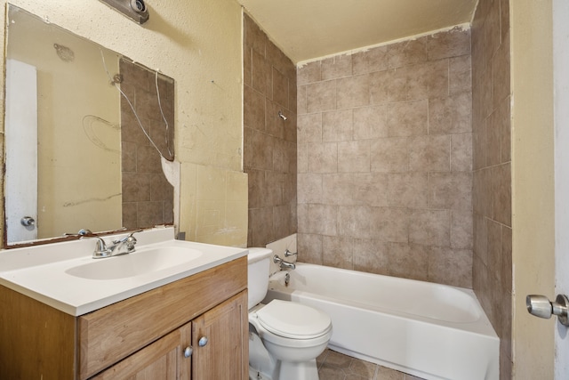 full bathroom with toilet, tiled shower / bath, and vanity