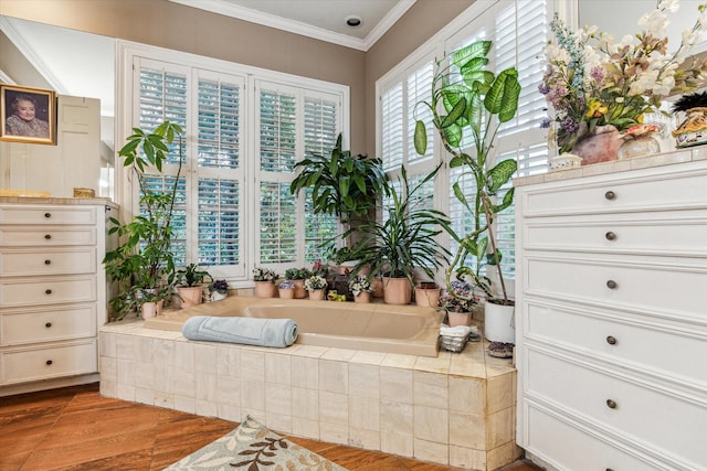 bathroom featuring wood finished floors, crown molding, vanity, and a bath