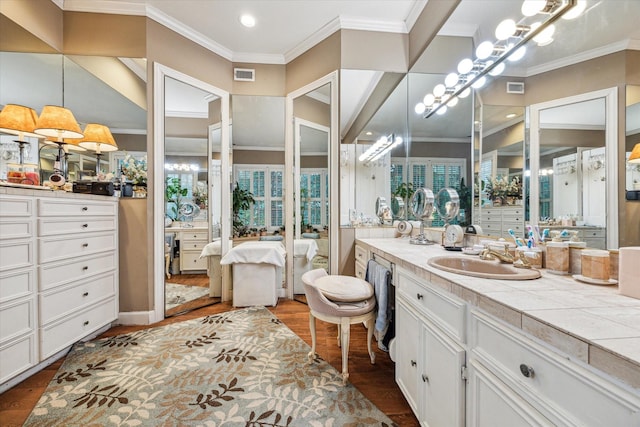 bathroom with visible vents, crown molding, ensuite bath, and wood finished floors